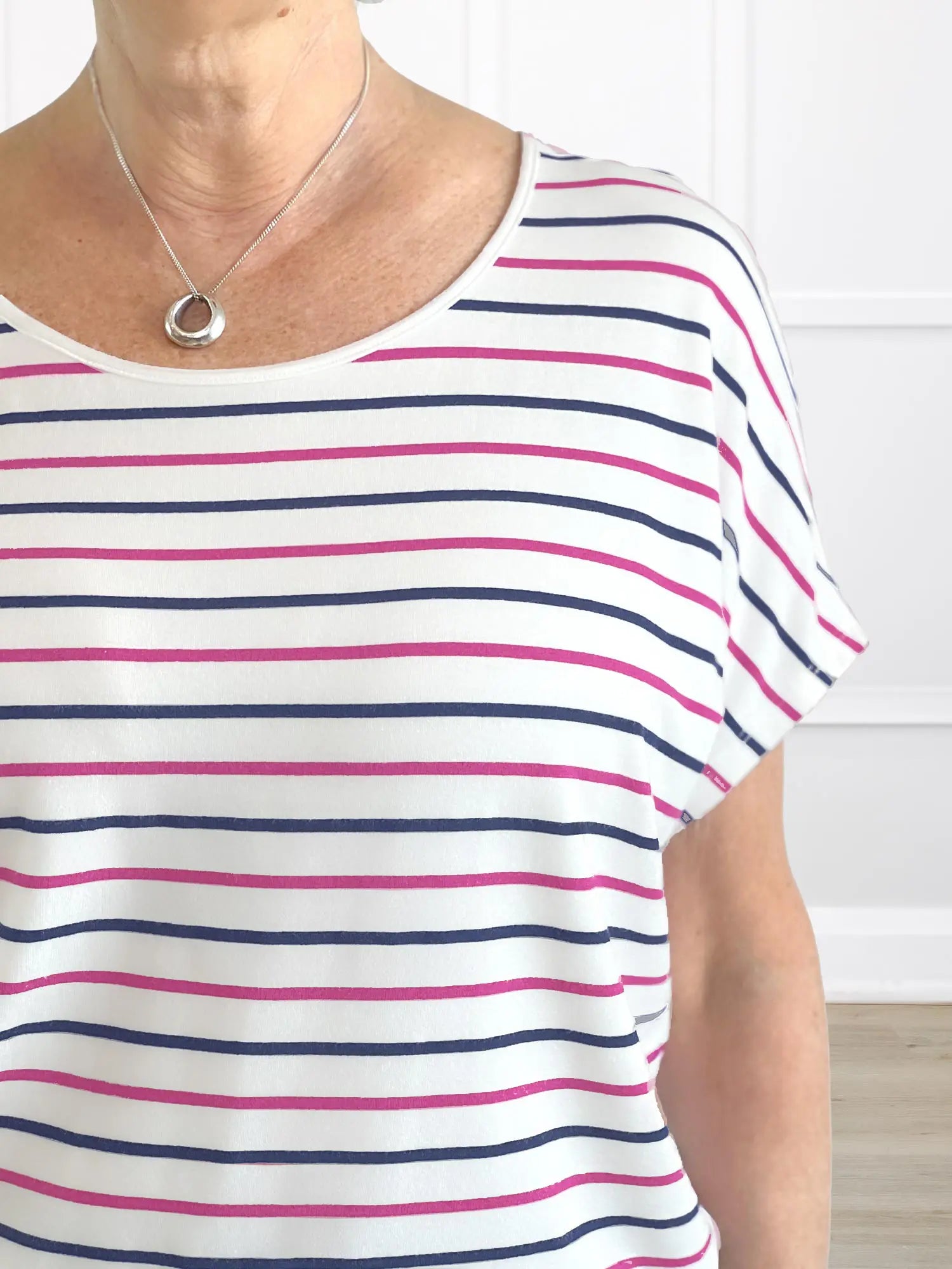 A closeup detail of the neckline and stripe of Miik&