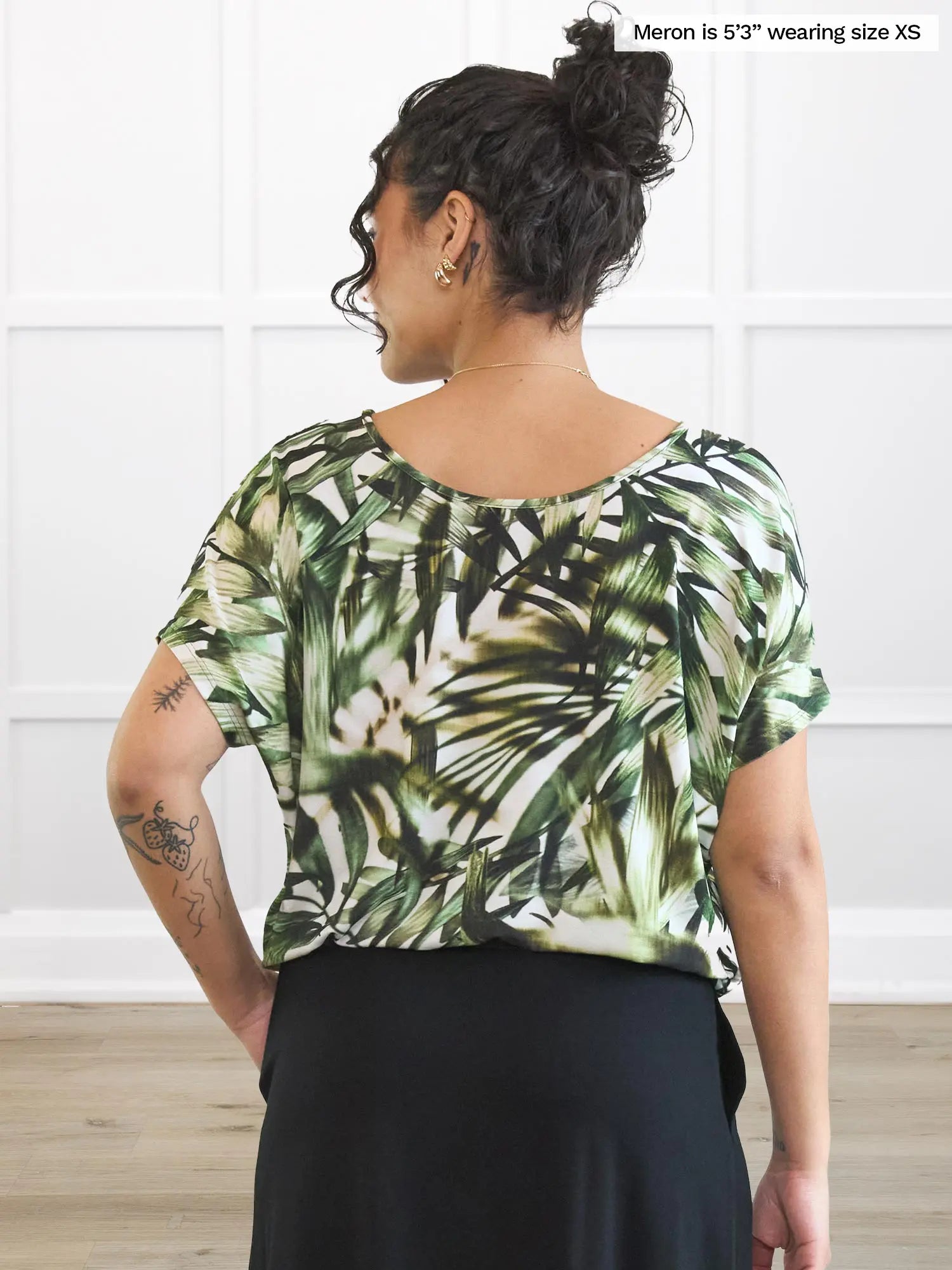 Miik model Meron (5’3”, xsmall) standing with her back towards the camera showing the back of Miik&
