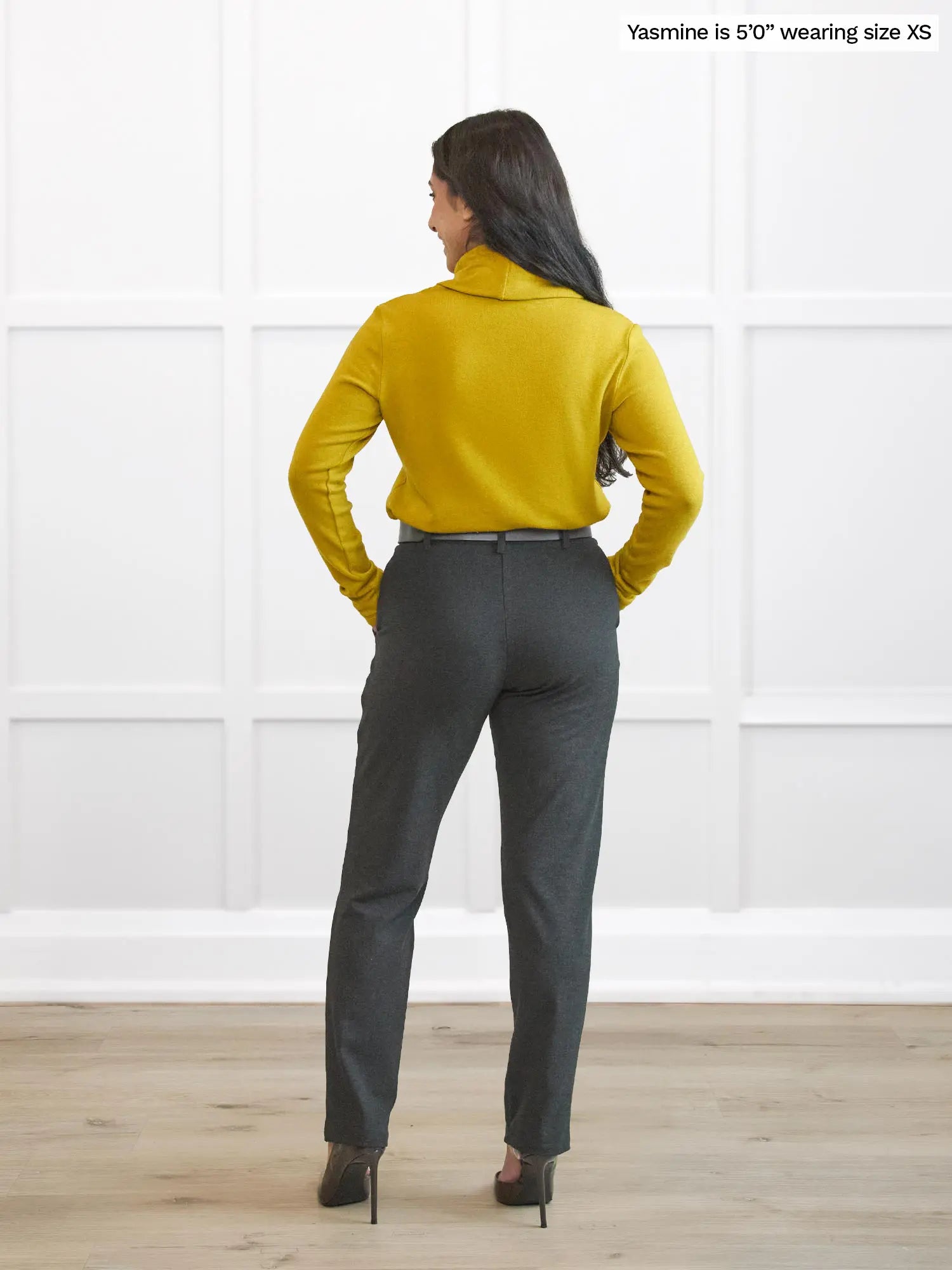 Miik model Yasmine (5’0”, xsmall) standing with her back towards the camera showing the back of Miik&