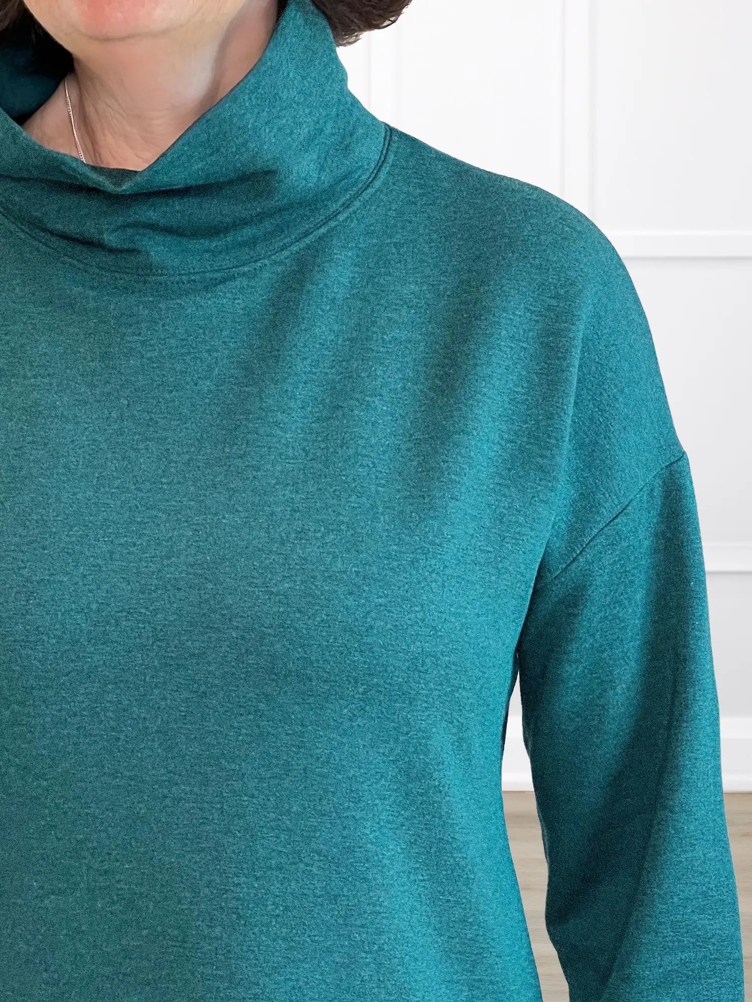 A closeup detail shot of the cowl neckline of Miik&