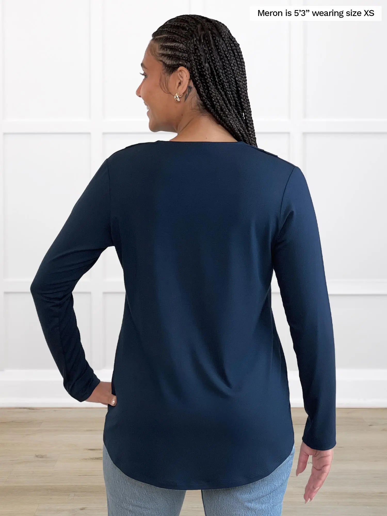 Miik model Meron (5’3”, xsmall) standing with her back towards the camera showing the back of Miik&
