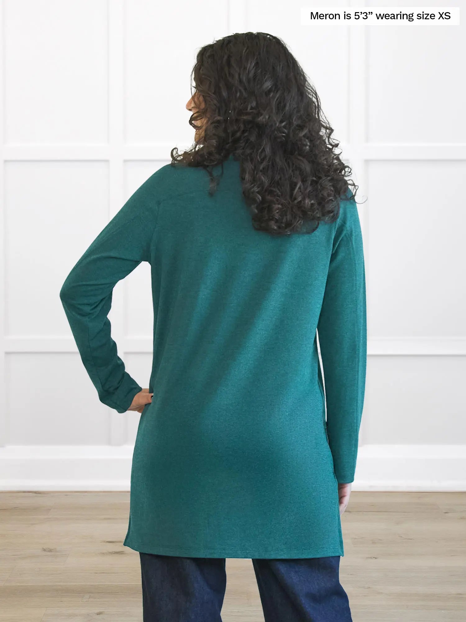 Miik model Meron (5’3”, xsmall) standing with her back towards the camera showing the back of Miik&