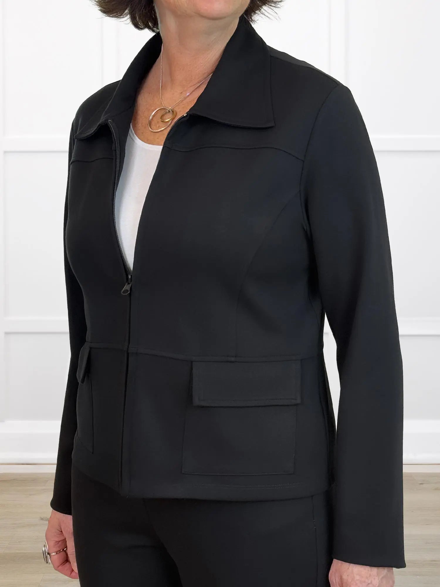 Person wearing a black jacket with a white background