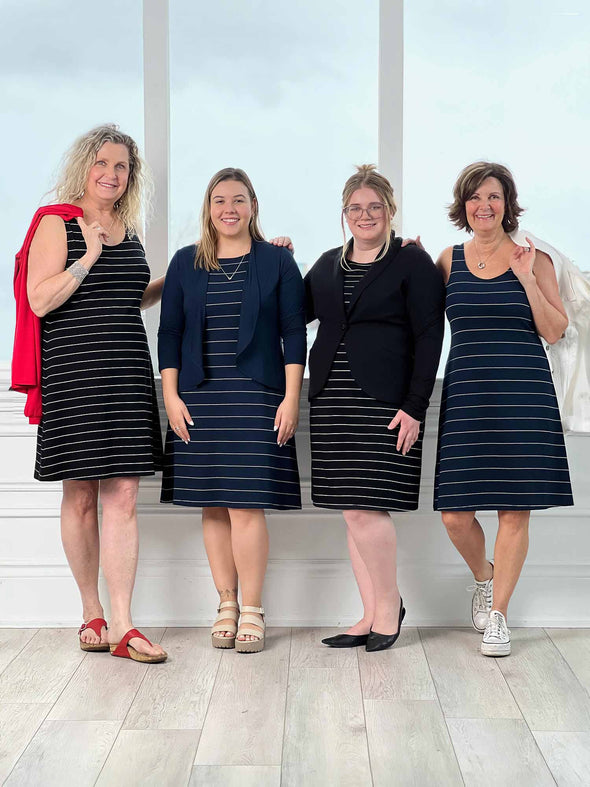 Miik models Carolyn, Christal, Bri and founder Donna smiling while standing next to each other all wearing Miik's Jaaron reversible knee length tank dress