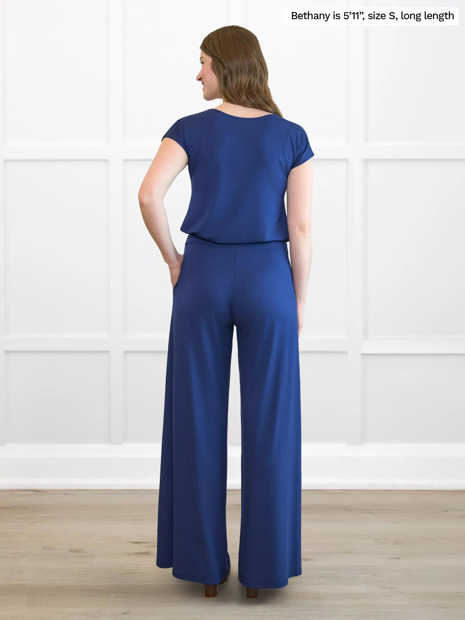 Miik model Bethany (5’11”, small, long length) standing with her back towards the camera showing the back of Miik&