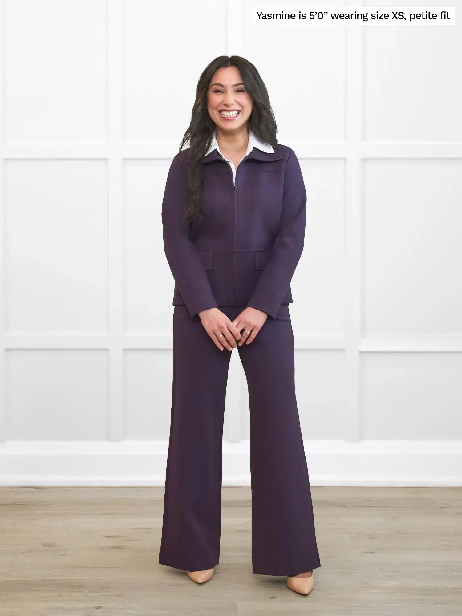 Woman wearing a purple outfit with a white shirt against a white background