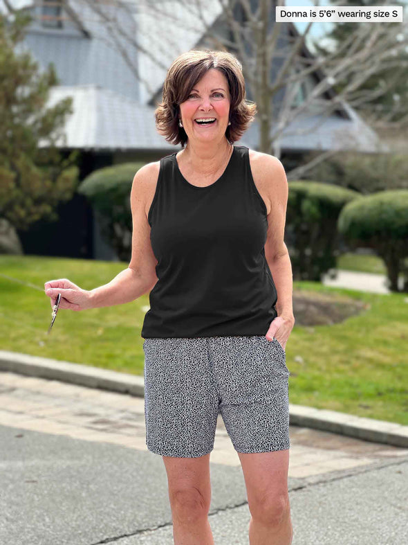 Miik founder Donna (5'6", small) smiling wearing Miik's Kavya pull-on casual print shorts in pebble with a black tank top