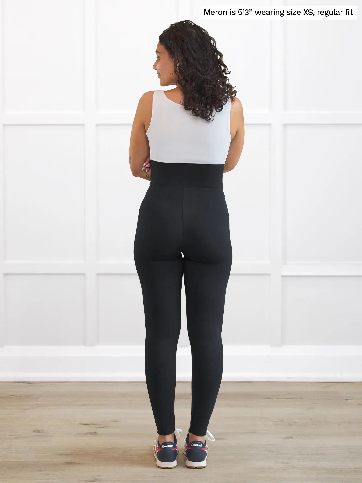Miik model Meron (5’3”, xsmall) standing with her back towards the camera showing the back of Miik&