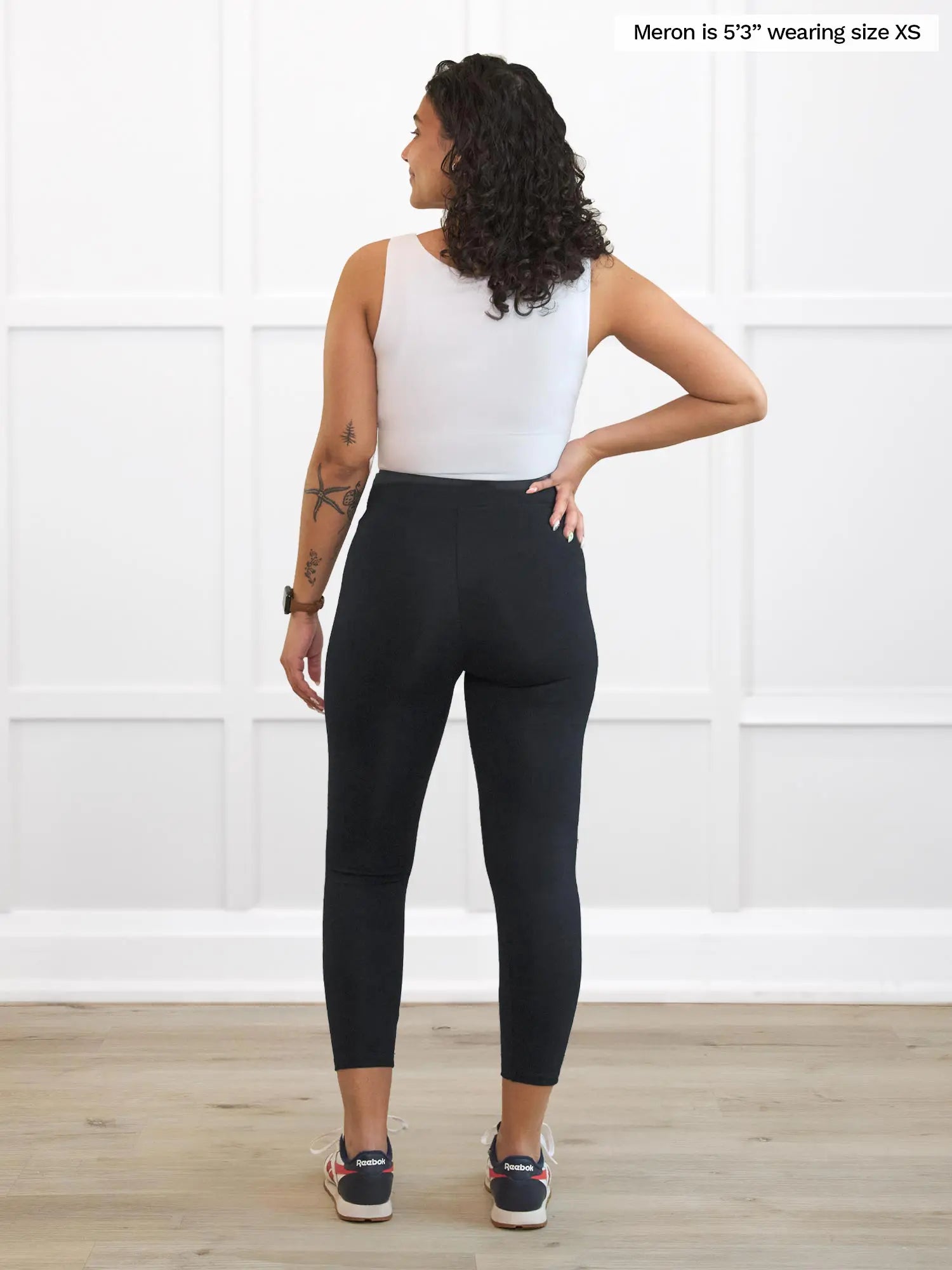 Miik model Meron (5’3”, xsmall) standing with her back towards the camera showing the back of Miik&