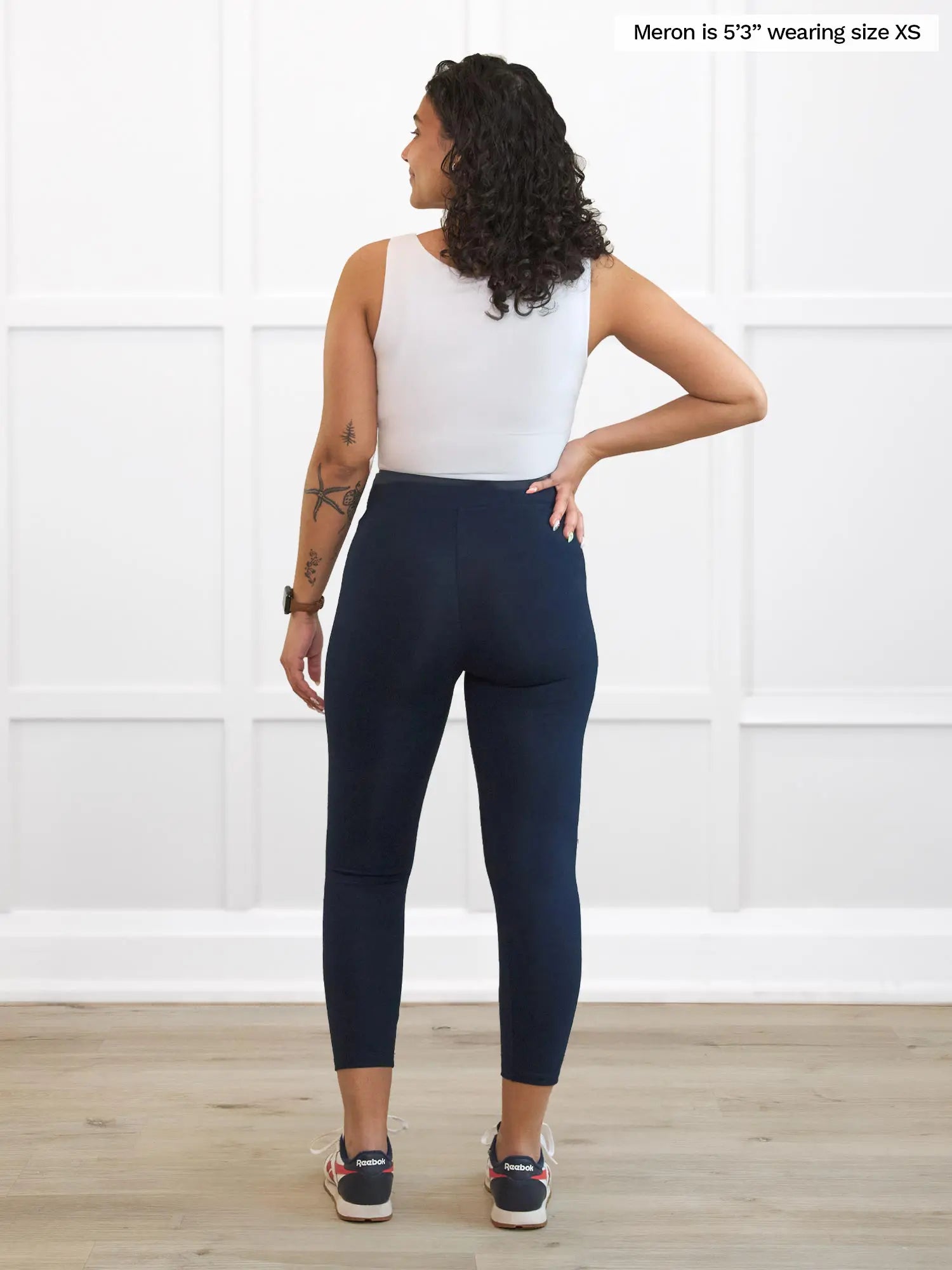 Miik model Meron (5’3”, xsmall) standing with her back towards the camera showing the back of Miik&