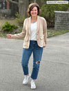 Miik founder Donna (5'6", small) smiling wearing a ripped jeans, sneakers, natural tank and Miik's Maeve LightLuxe washable blazer in wheat in a casual look