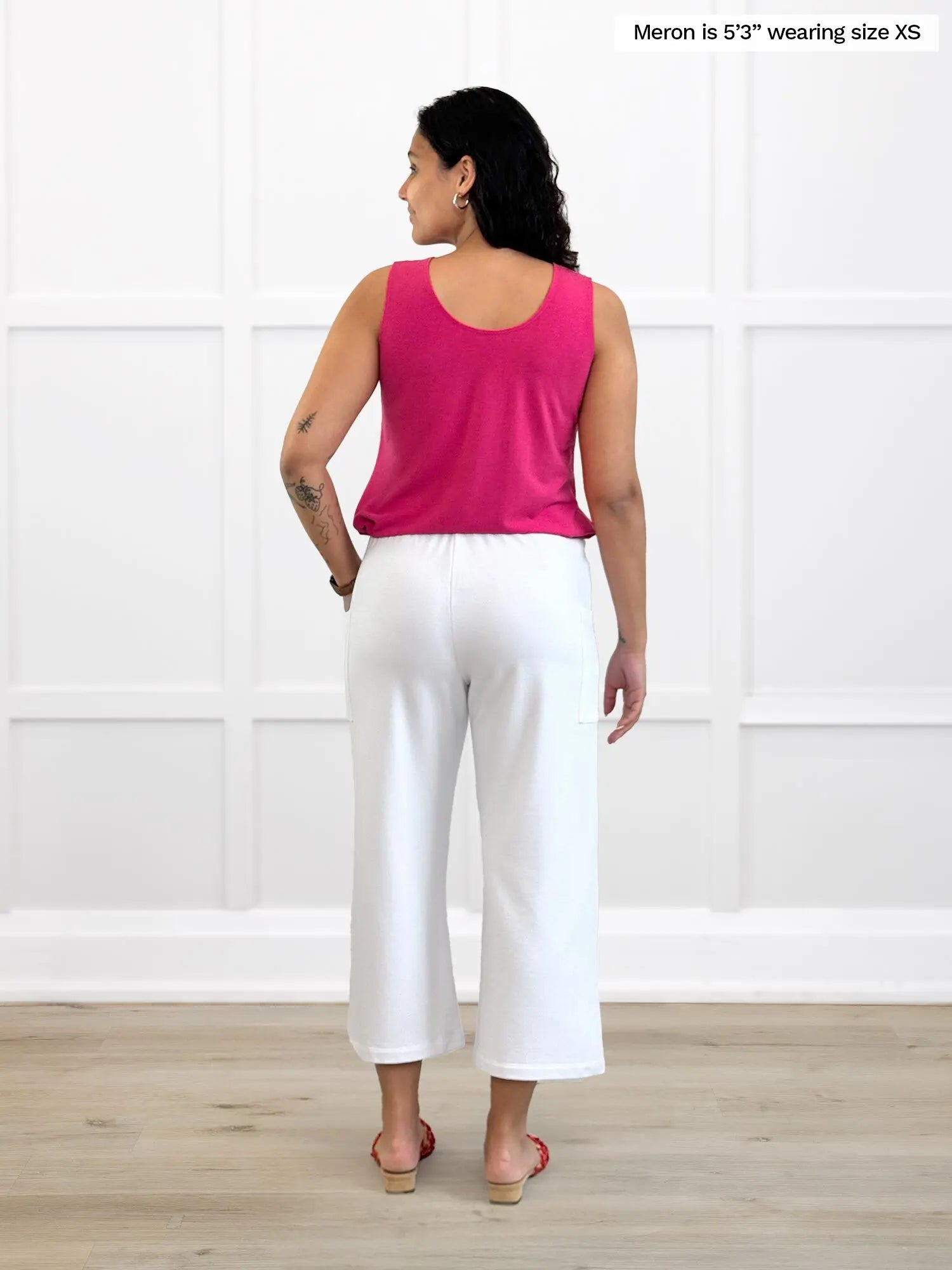Miik model Meron (5’3”, xsmall) standing with her back towards the camera showing the back of Miik&