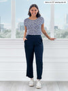 Woman standing in front of a window wearing Miik's Rio reversible dolman tee in blue ditsy print and pants
