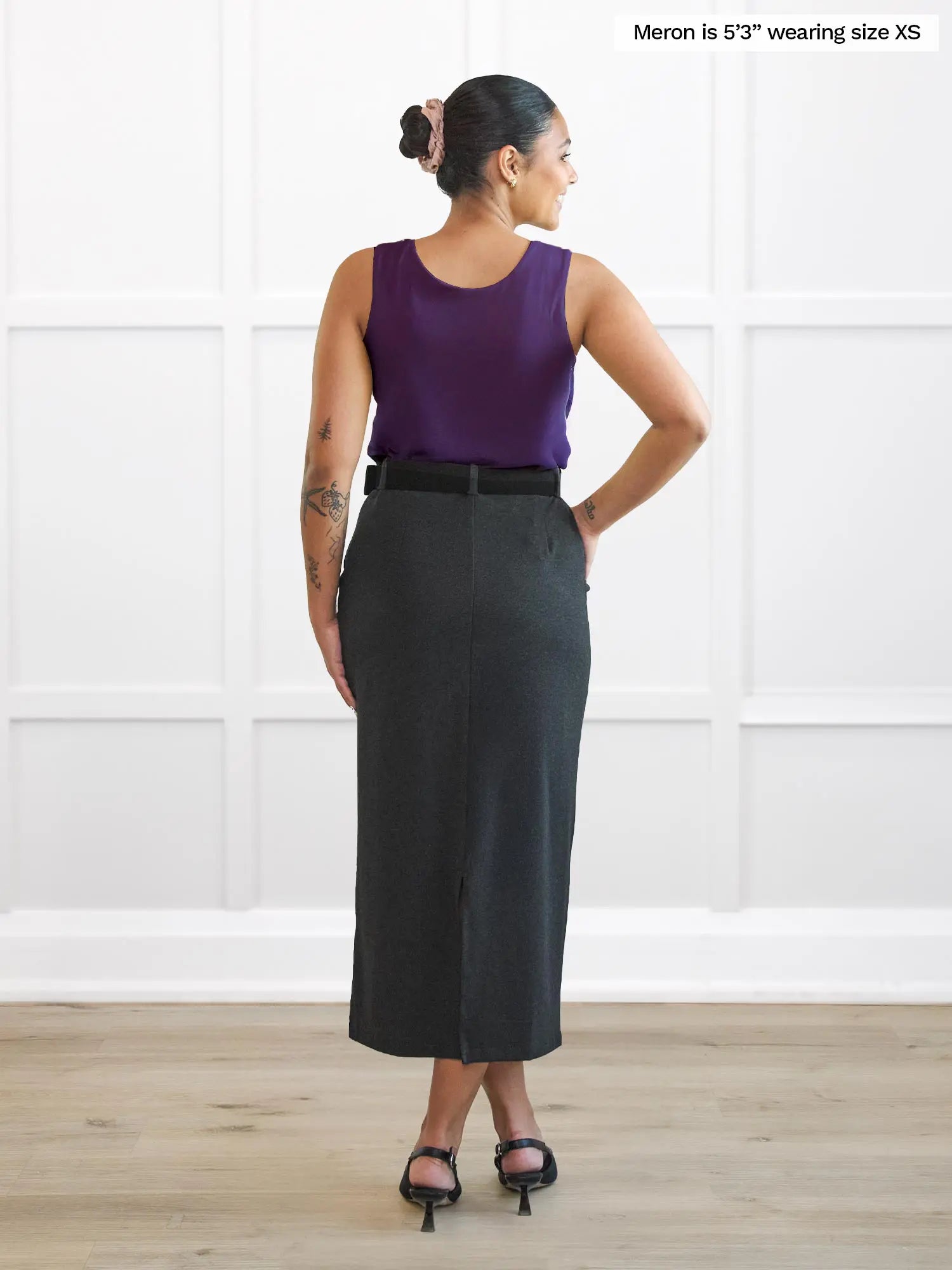 Miik model Meron (5’3”, xsmall) standing with her back towards the camera showing the back of Miik&