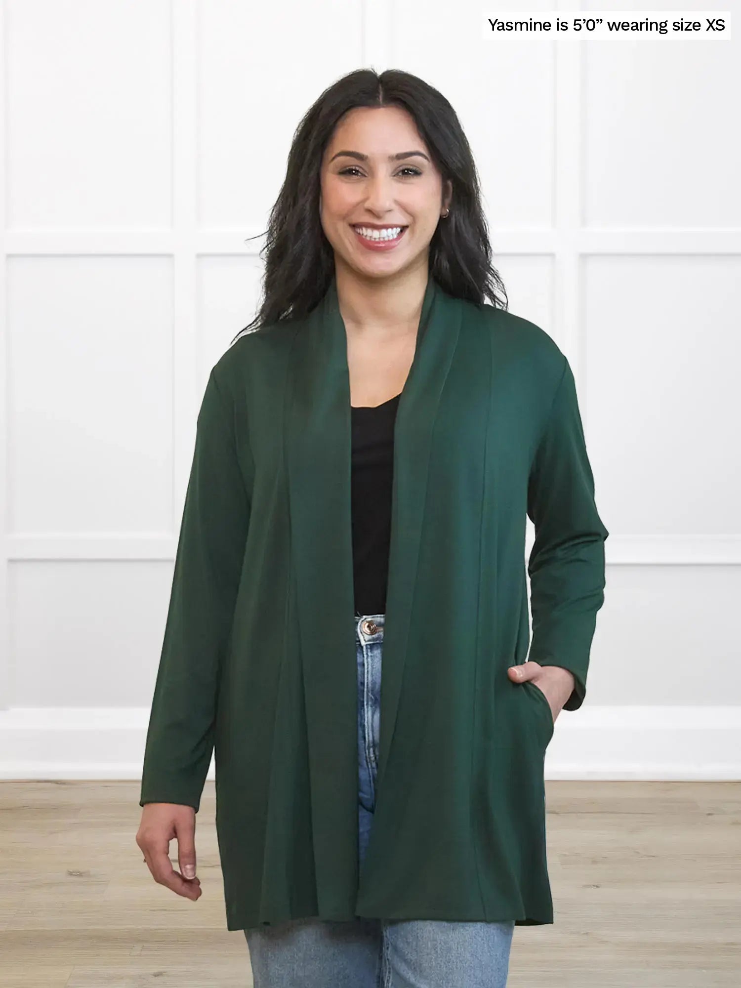 Woman wearing a green cardigan against a white background