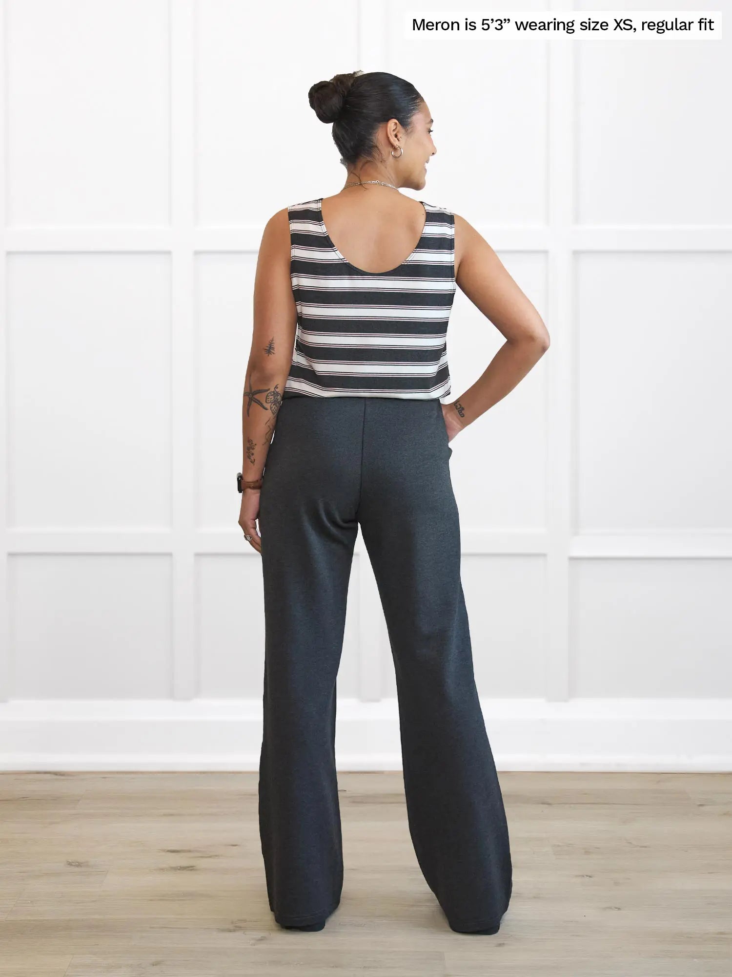 Miik model Meron (5’3”, xsmall) standing with her back towards the camera showing the back of Miik&