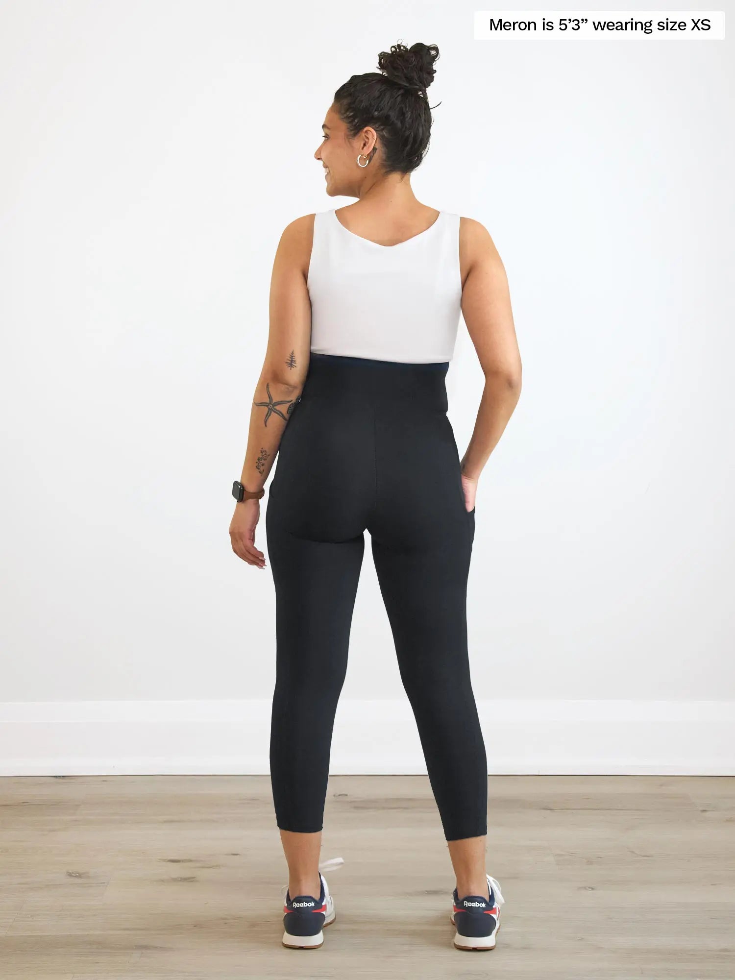 Miik model Meron (5’3”, xsmall) standing with her back towards the camera showing the back of Miik&