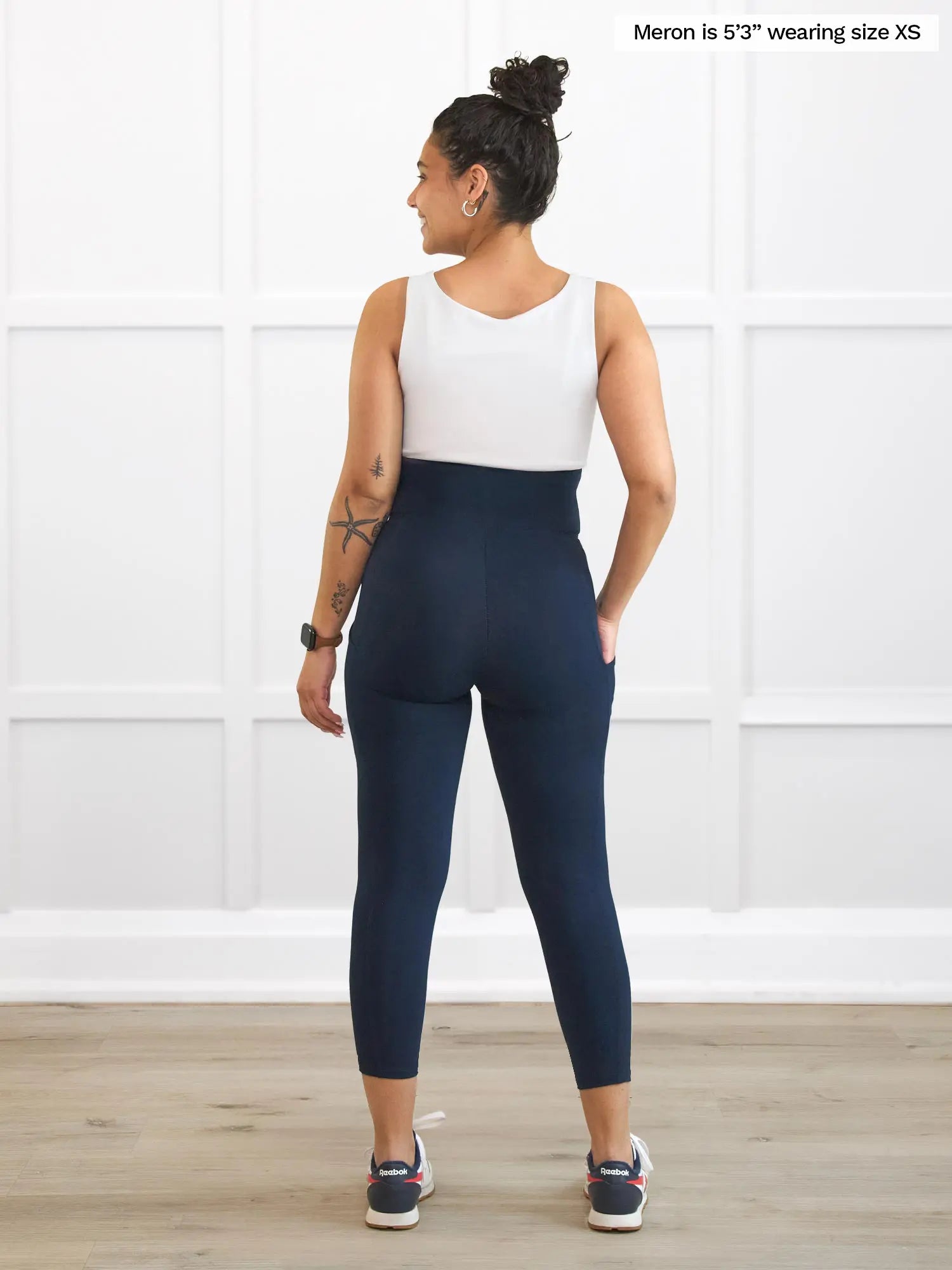 Miik model Meron (5’3”, xsmall) standing with her back towards the camera showing the back of Miik&