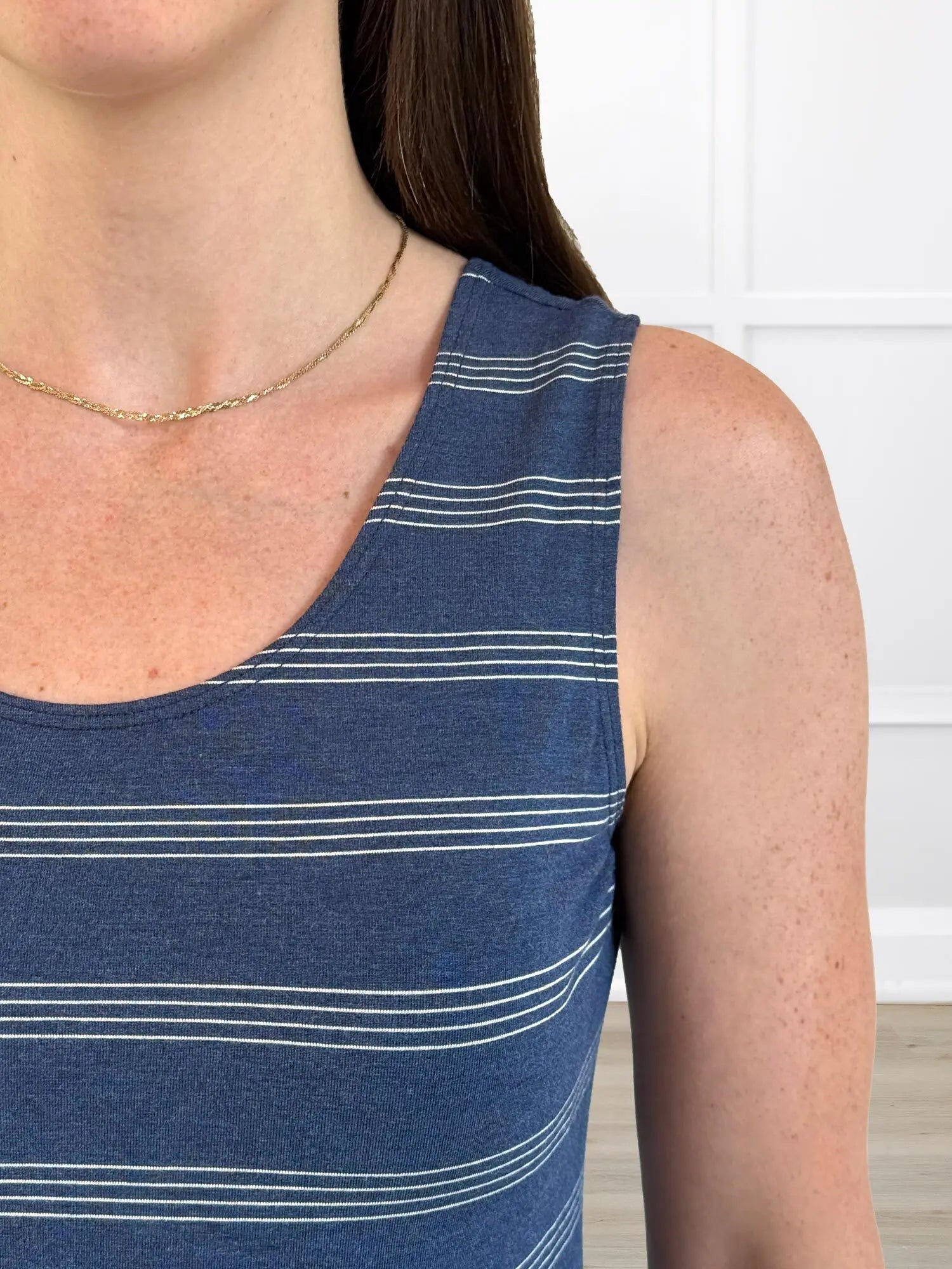 A closeup detail shot of the neckline and strap of Miik&