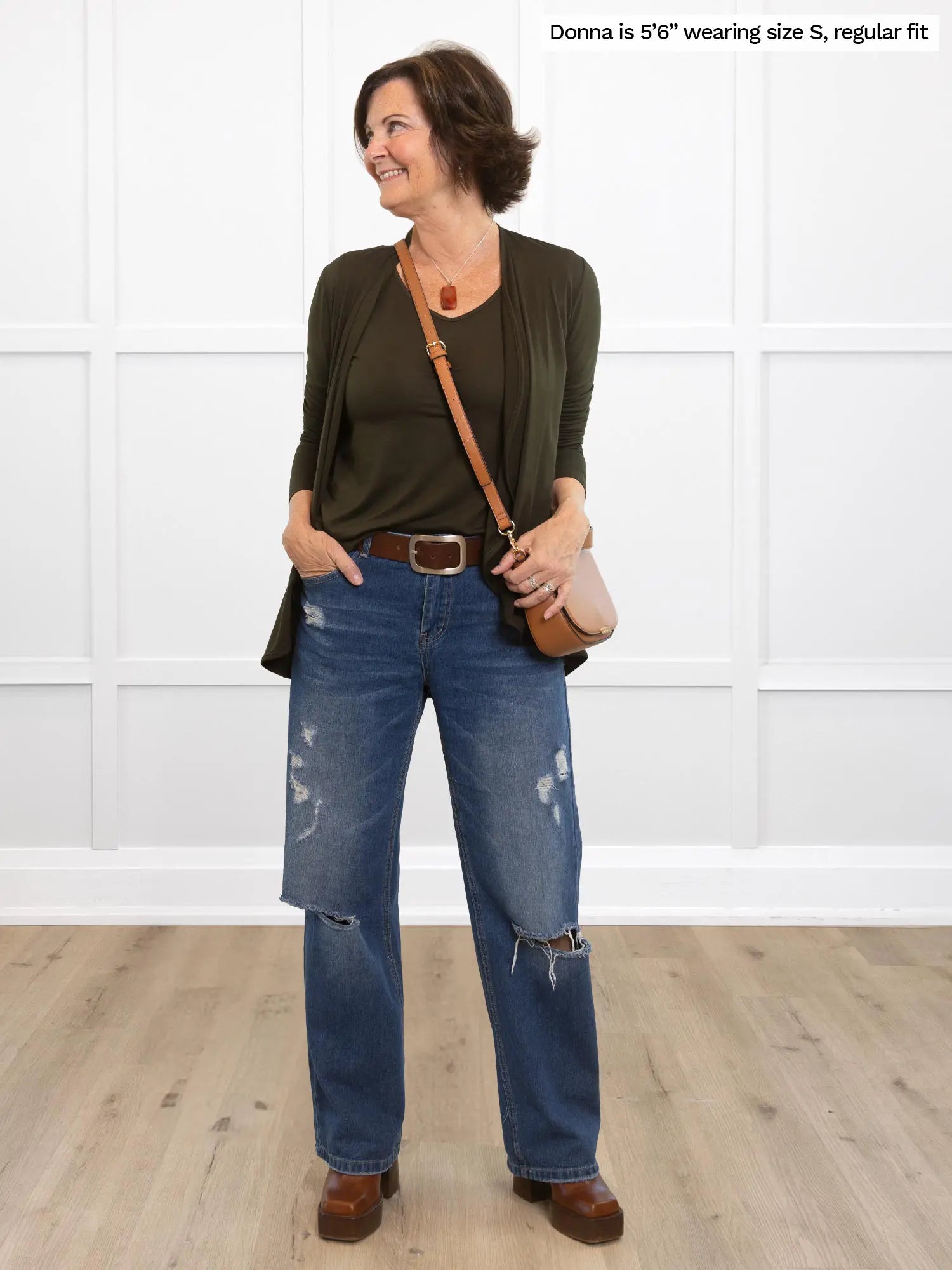 Miik founder Donna is wearing the Shannon reversible long sleeve t-shirt in olive green under a matching cardigan with belted blue jeans.