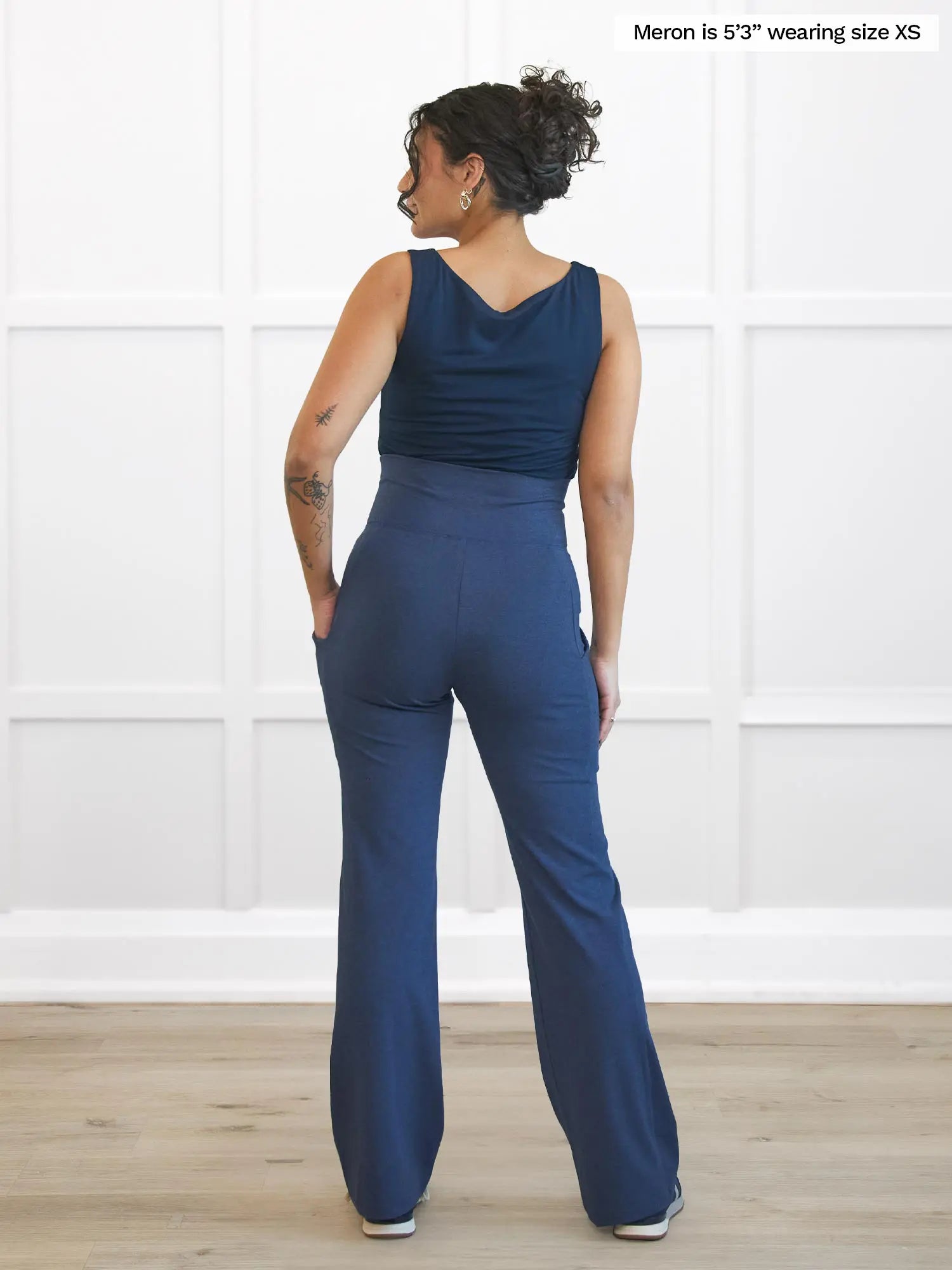 Miik model Meron (5’3”, xsmall) standing with her back towards the camera showing the back of Miik&