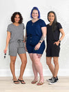 Miik models Meron, Kaitlin and Lisa all smiling and wearing the same romper: the Miik's Tanya short sleeve open-back. Meron is wearing in pebble print, Kaitlin in ink blue and Lisa in black 