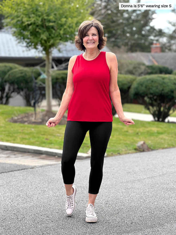 Miik founder Donna (5'6", small) smiling wearing Miik's Teanna scoop neck tank top in poppy red with a capri legging in black
