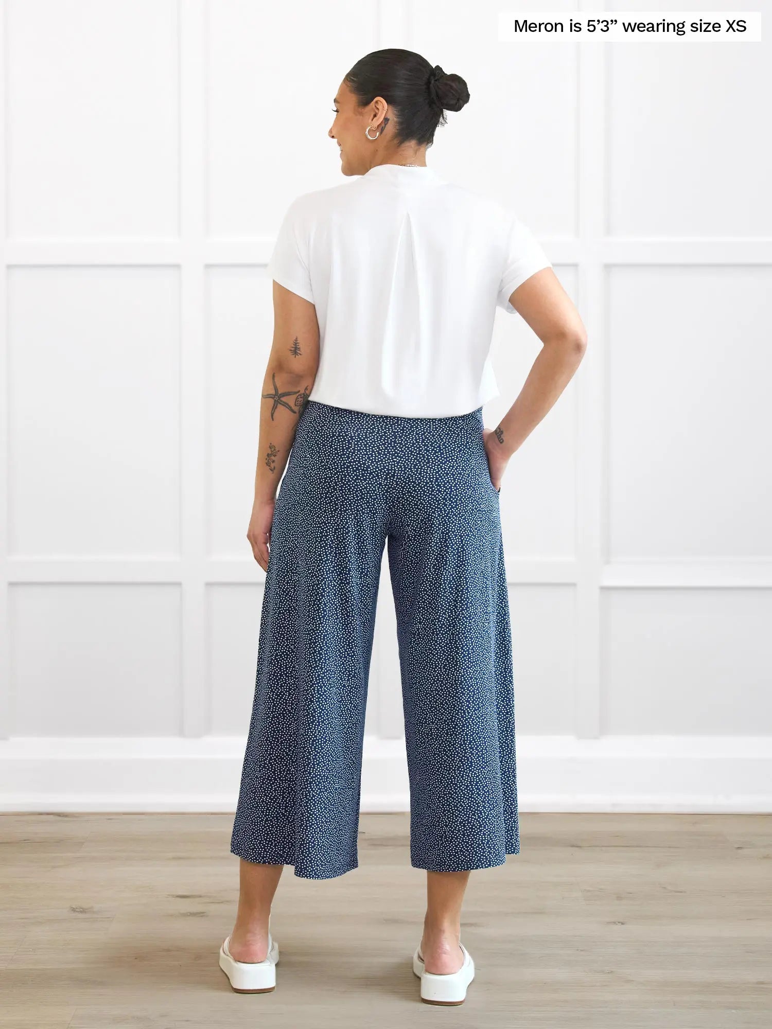 Miik model Meron (5’3”, xsmall) standing with her back towards the camera showing the back of Miik&