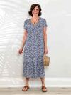 Miik founder Donna (5'6, small) smiling wearing Miik's Zilma reversible puff sleeve midi dress in baby's breath 