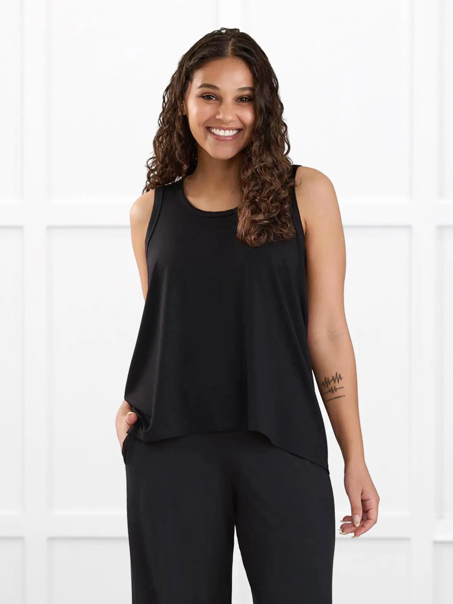 Anjuli flowy scoop neck tank for women in Black on model Meron, size XS @Meron-XS