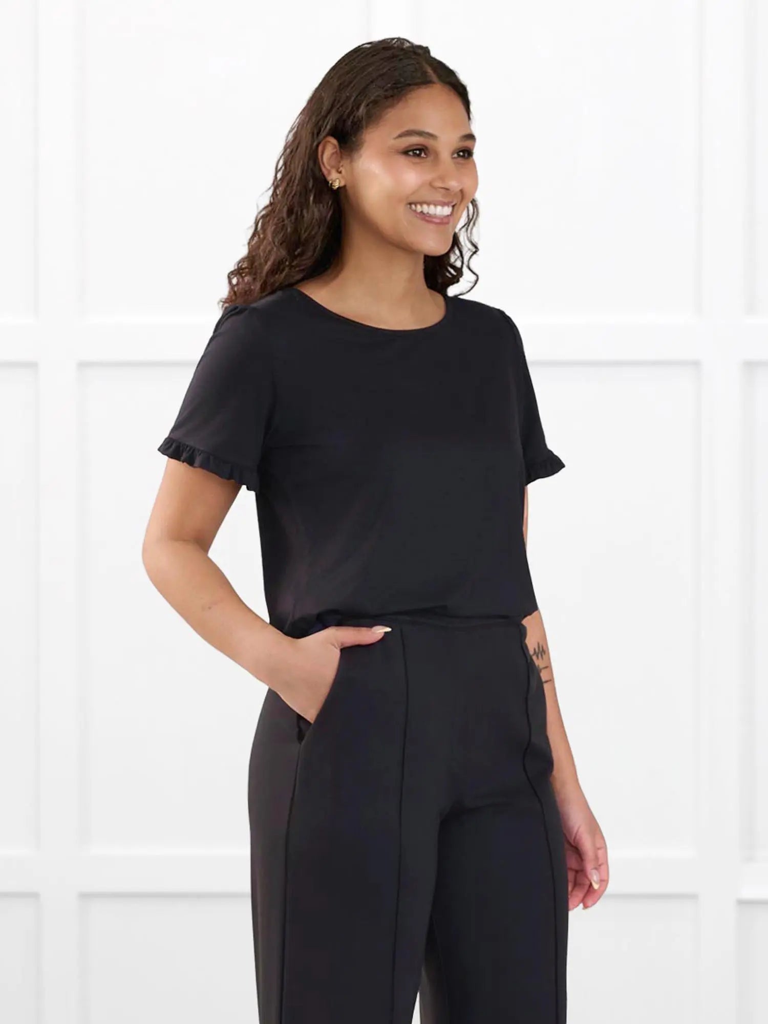 Darlene reversible neckline ruffle sleeve top for women in Black on model Meron, size XS @Meron-XS