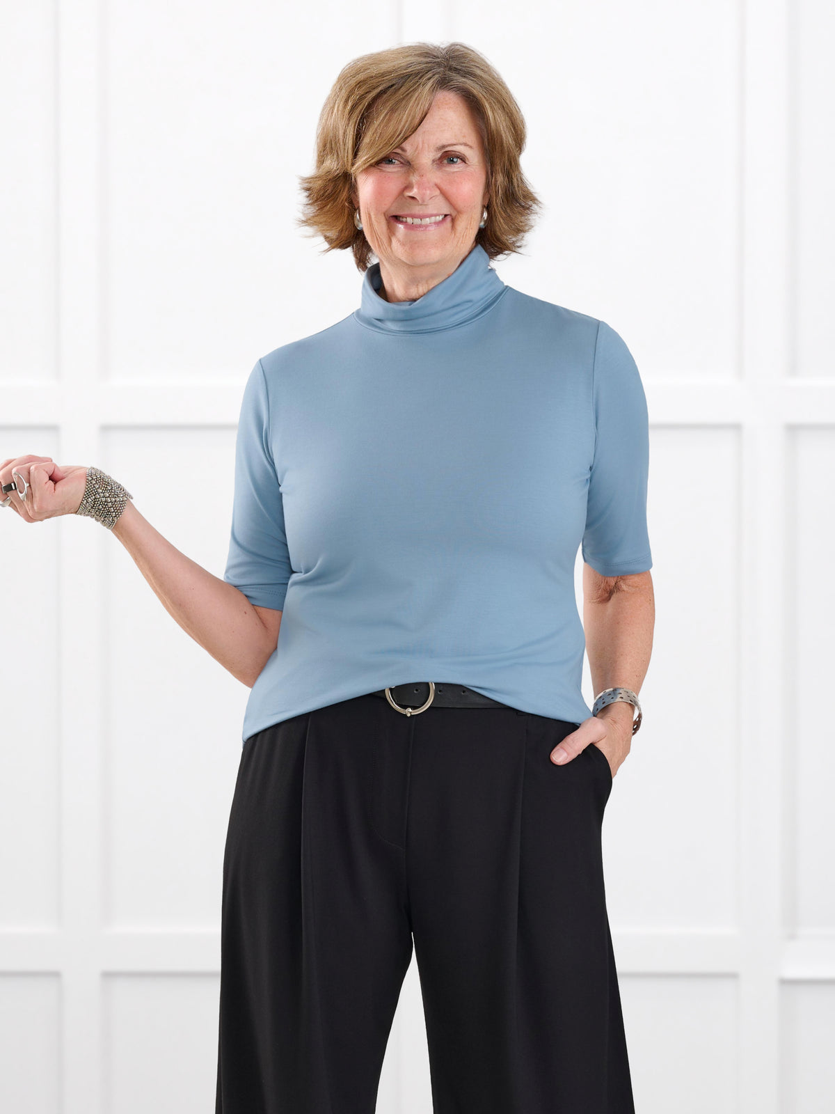 Halima half sleeve turtleneck top for women in Steel blue on model Donna, size S @Donna-S