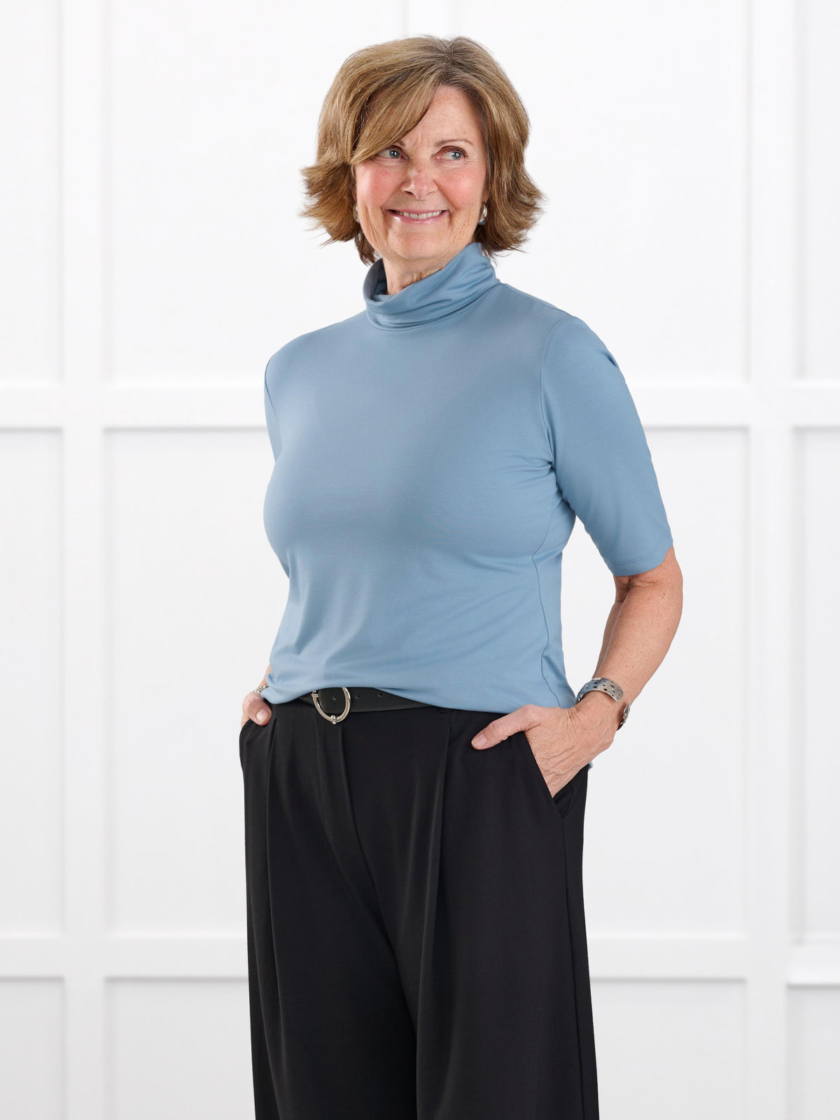 Halima half sleeve turtleneck top for women in Steel blue on model Donna, size S @Donna-S