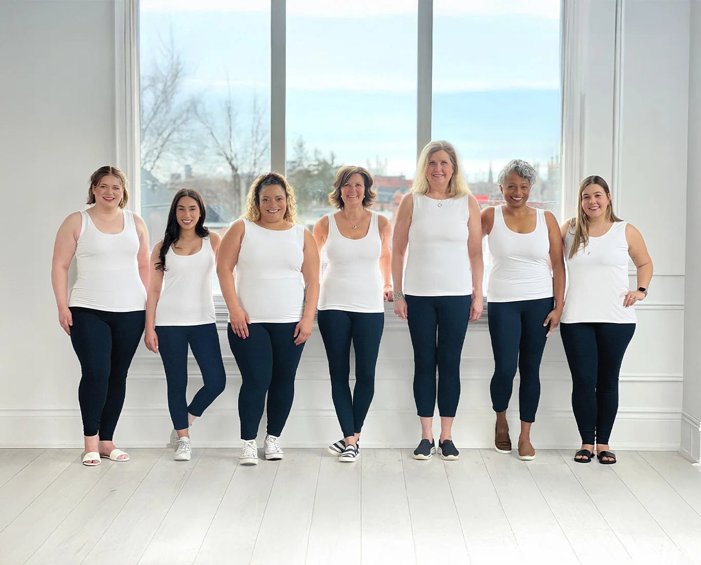 A group of Canadian Miik models of all different sizes, shapes and ages standing and smiling.