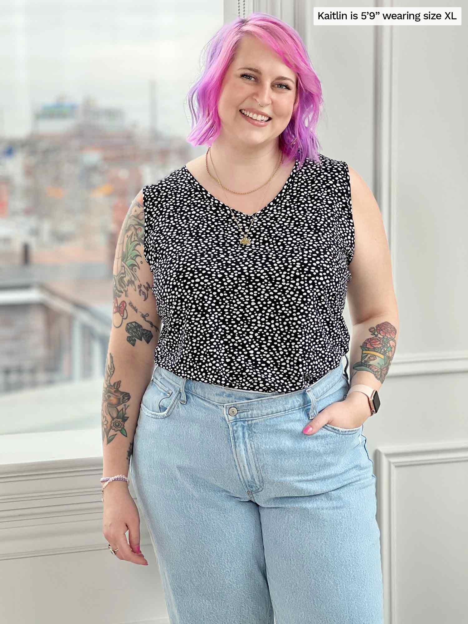 Woman smiling standing in front of a window wearing Miik&