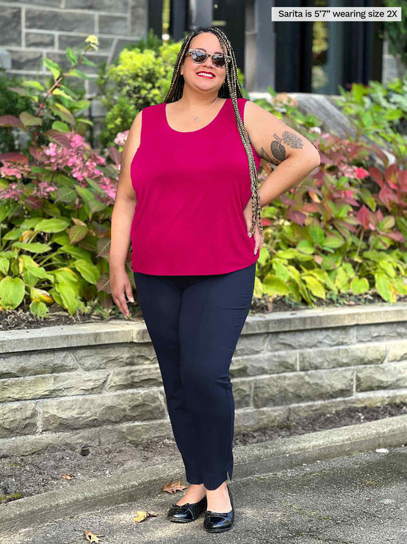 Miik model plus size Sarita (5'7", 2x) smiling wearing Miik's Alanis relaxed tank top in bordeaux along with a navy pant