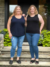 Miik models Bri and Jen standing next to each other smiling both wearing Miik's tank top. Bri (5'5", xlarge) is wearing Shandra reversible in black and Jen (5'8", 3x) is wearing the new Miik's Alanis relaxed tank top in navy