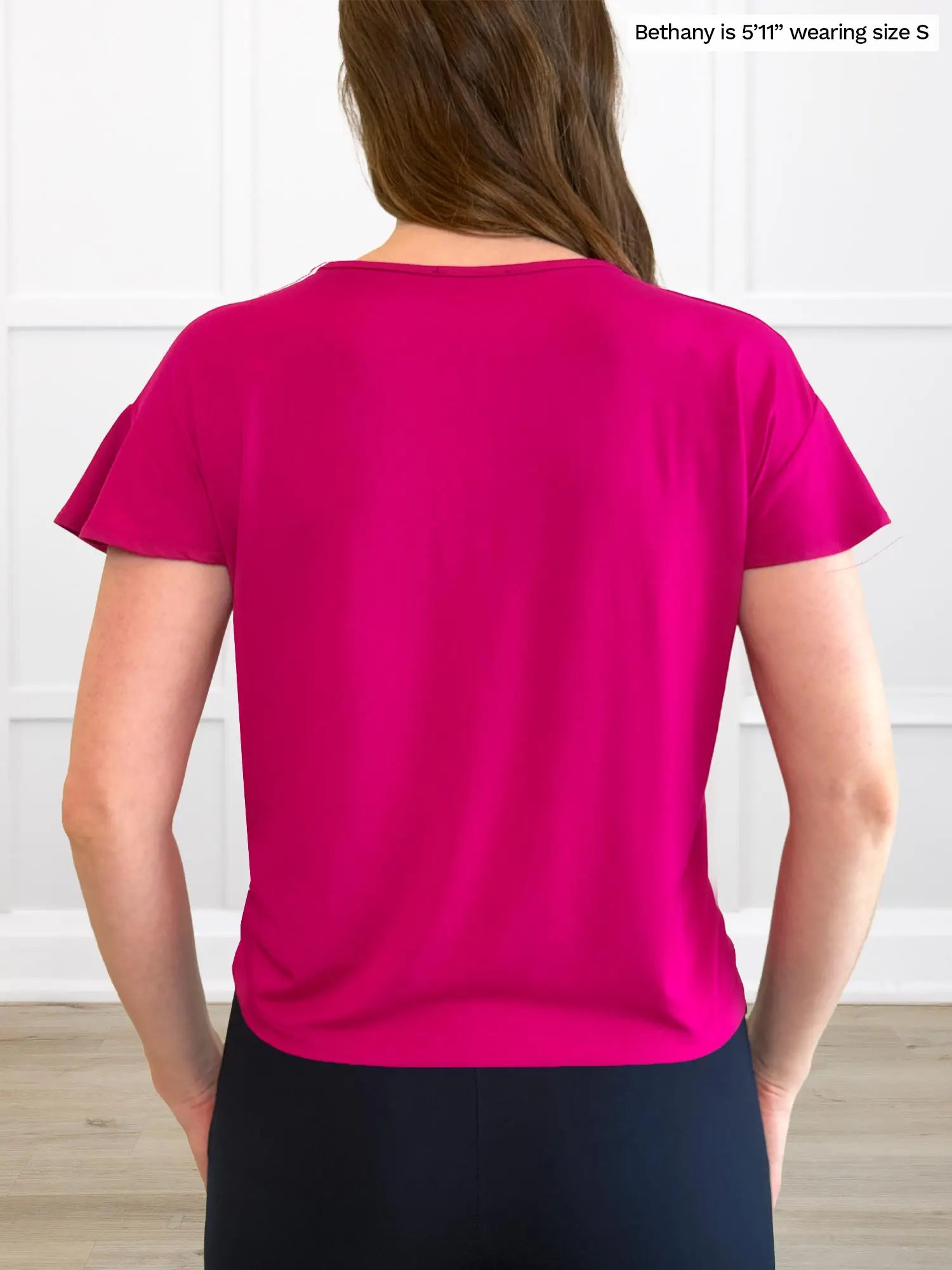 Miik model Bethany (5’11”, small) standing with her back towards the camera showing the back of Miik&