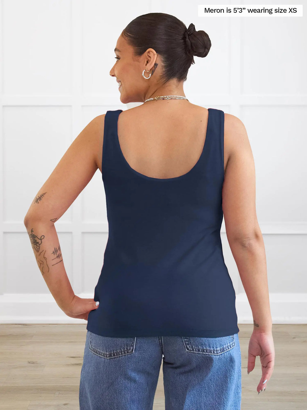 Miik model Meron (5’3”, xsmall) standing with her back towards the camera showing the back of Miik&