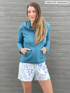 Miik model Johanna (five feet six, xsmall) wearing Miik's Amita PJ lounge set shorts in ocean leaf with Essex fleece hoodie in teal melange