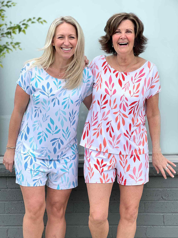 Miik CEO Sue and founder Donna smiling are both wearing Miik's Amita PJ lounge set in the two prints available: ocean leaf and sunset leaf