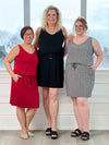 Miik models Mary-Ann, Carolyn and Bri standing next to each other smiling all wearing the Miik's Amy drawstring pocket dress: in pebble, black and poppy red