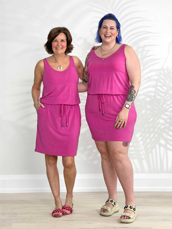 Miik founder Donna and model Kaitlin standing next to each other both wearing the same dress: the Amy drawstring pocket dress in pink showing different sizes and body type of real women 