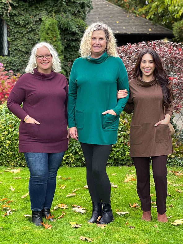Miik models Colleen, Carolyn and Yasmine standing next to each other smiling showing the different sizes and colours of Miik's 		Ashanti long sleeve cowl neck pocket tunic: port melange, jade melange and chocolate melange 