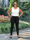 Miik model Pat (5'8", large) laughing wearing a natural tank with Miik's Asia mid-rise slim pant long length in black