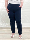 A close up image of Miik's Asia mid-rise slim pant in navy short length