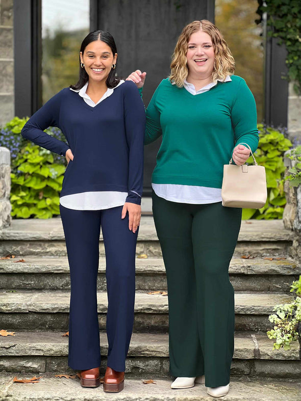 Miik models Meron and Bri smiling while standing next to each other both wearing Miik's Carson collared faux-layer shirt: navy and jade melange