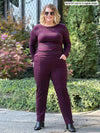 Miik model Bri (size XL, five foot five) wearing the Christal pull-on pintuck pant in port burgundy with a matching striped long sleeve top.