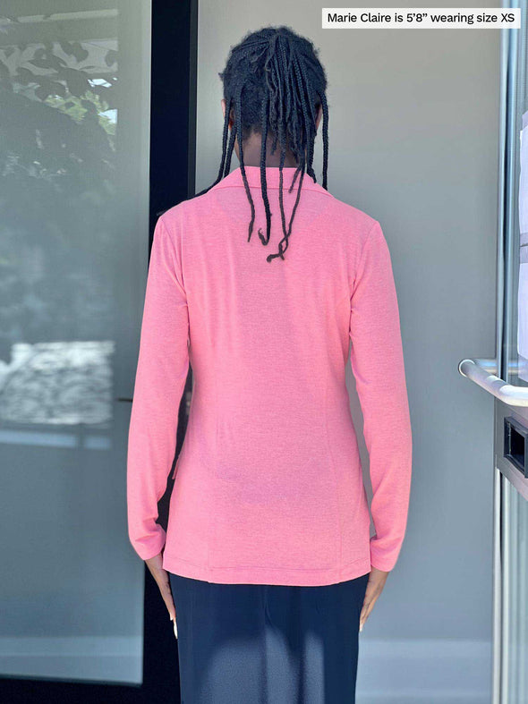 Woman standing with her back towards the camera wearing Miik's Danica lightweight tailored blazer in pink with a navy skirt.