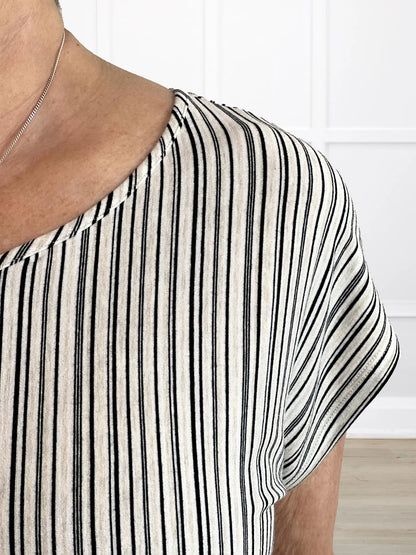 A closeup detail of the neckline of Miik&